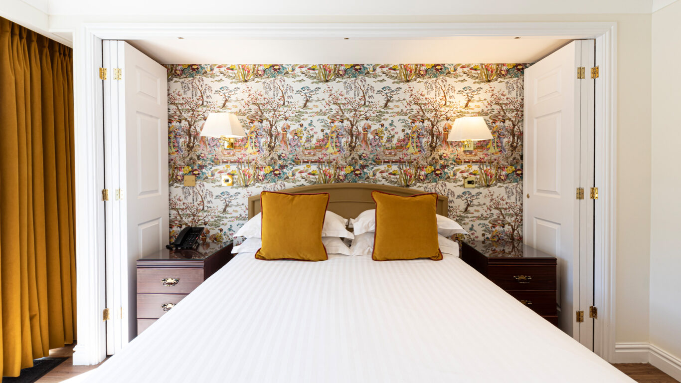 Room-112-Classic-King-Dog-Friendly-Old-Reception-View-Bed-&-Wallpaper